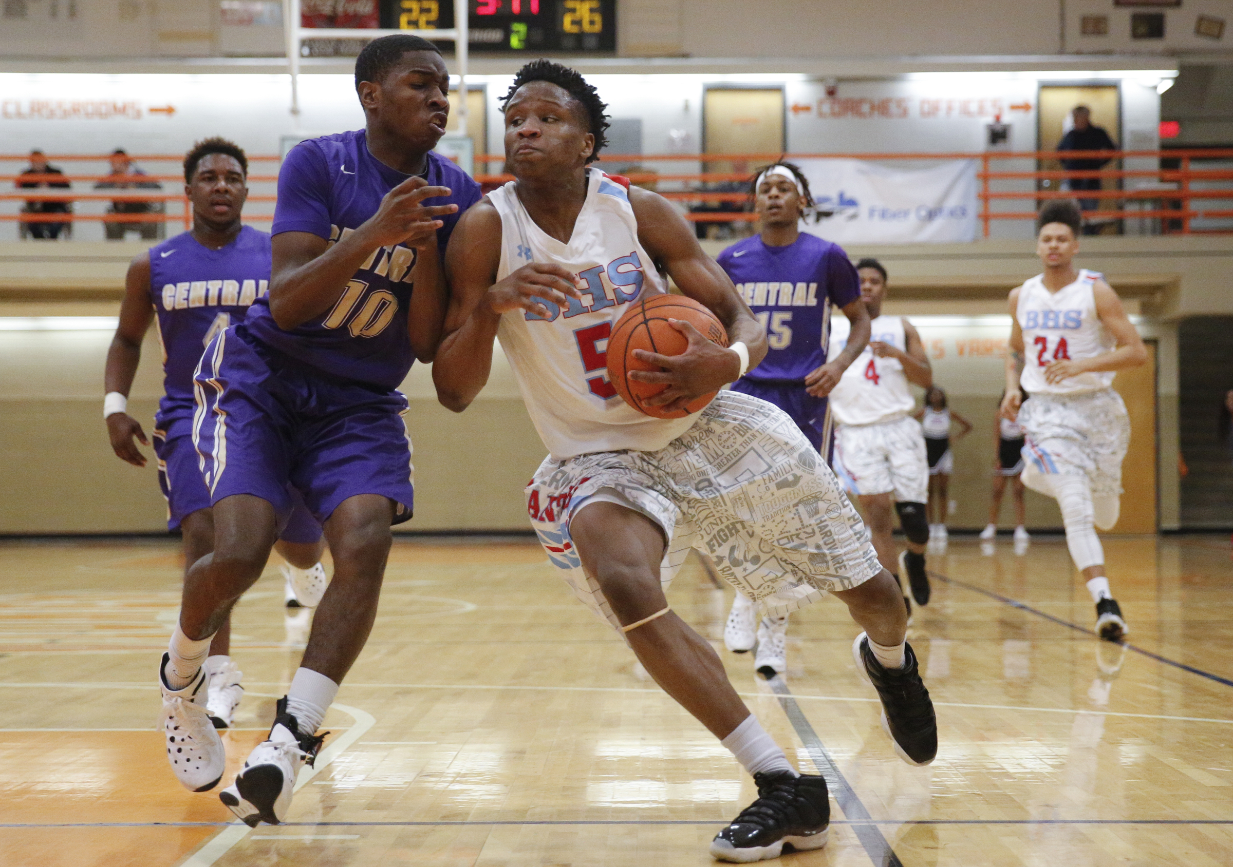 Brainerd's Dajuonta Ross (5) tries to find room for a layup around Central's Dajon Baxter during their Region 3-AA boys' basketball tournament championship game at East Ridge High School on Thursday, March 3, 2016, in East Ridge, Tenn.