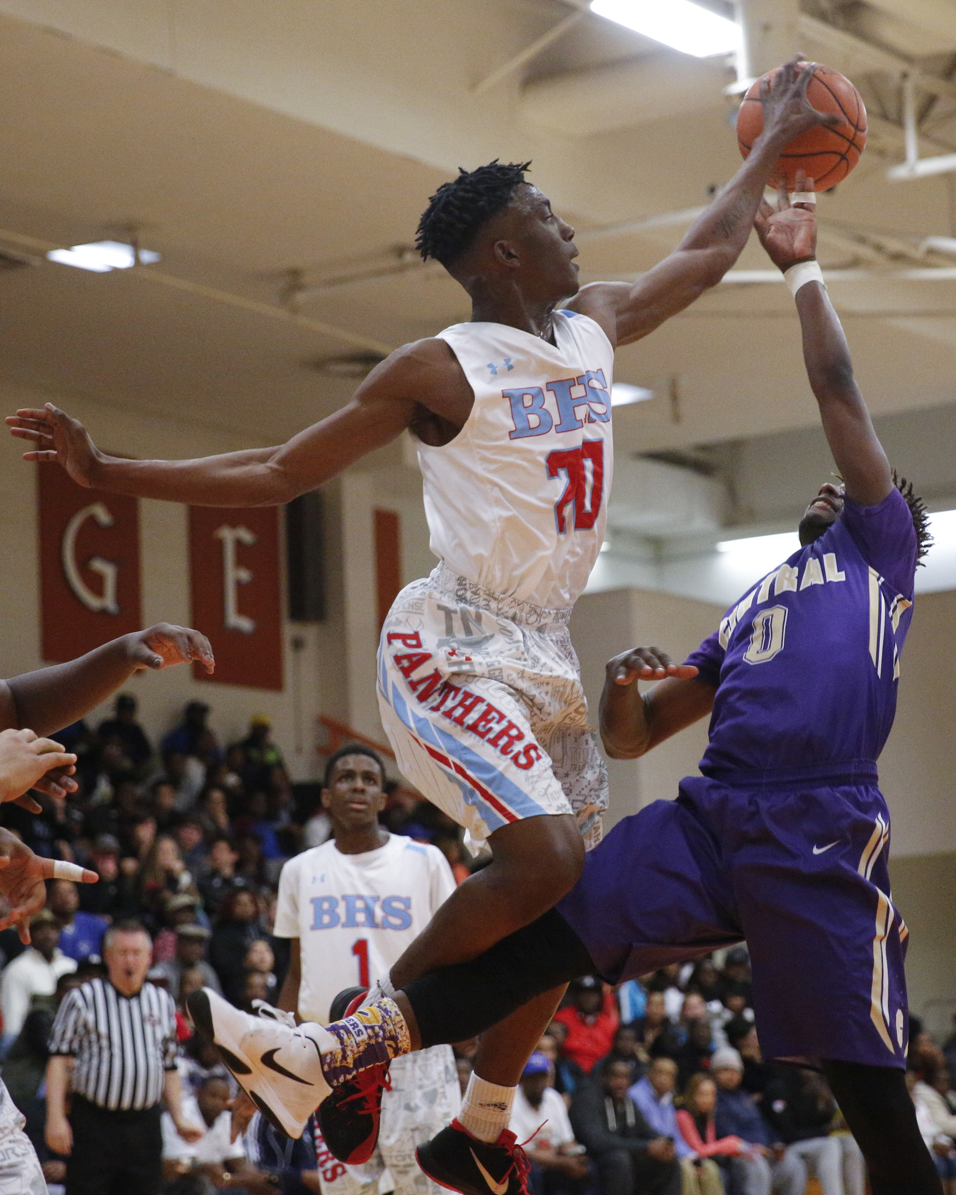Brainerd's Malik Beavers (20) knocks down a shot by Central's Emmanuel Lane (0) during their Region 3-AA boys' basketball tournament championship game at East Ridge High School on Thursday, March 3, 2016, in East Ridge, Tenn.