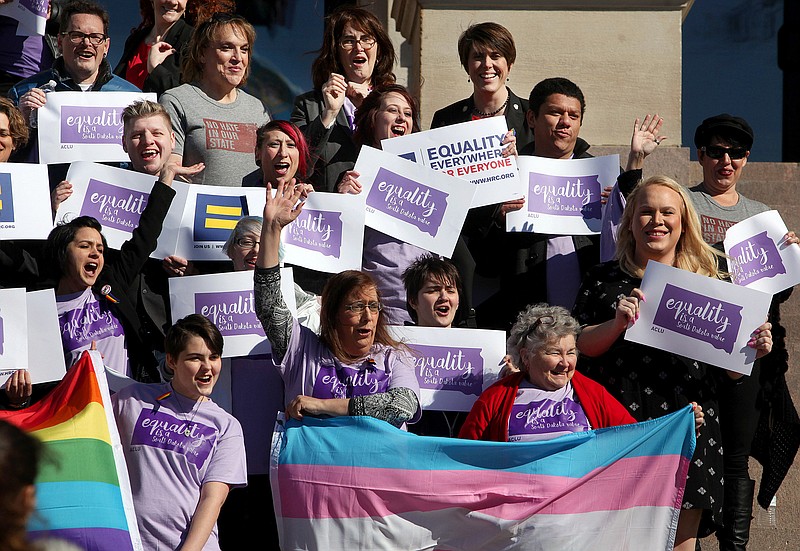 Representatives from the Center for Equality, American Civil Liberties Union of South Dakota, LGBT supporters and members of the Human Rights Campaign stand on the front steps of the State Capitol to honor Trans Kids Support Visibility Day in Pierre, S.D. on Tuesday, Feb. 23, 2016. Gov. Dennis Daugaard heard from several transgender people during a meeting Tuesday at the Capitol, where advocates gathered to urge the governor to veto a bill that would require students to use bathrooms and locker rooms that match their sex at birth. 