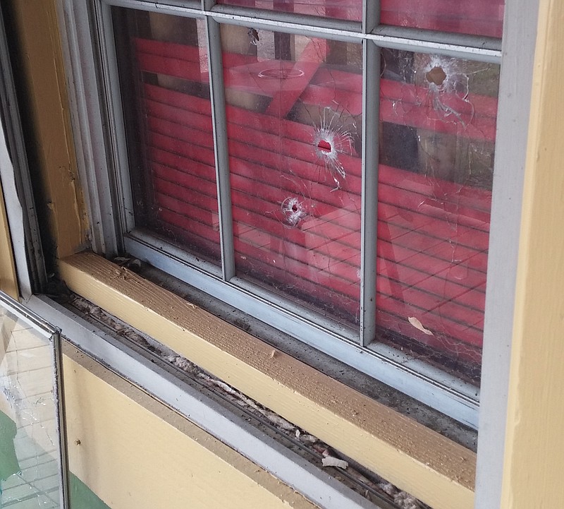 A photo shows bullet holes in the window of a former Chattanooga city employee who was killed by a high-powered rifle during a drive-by shooting.