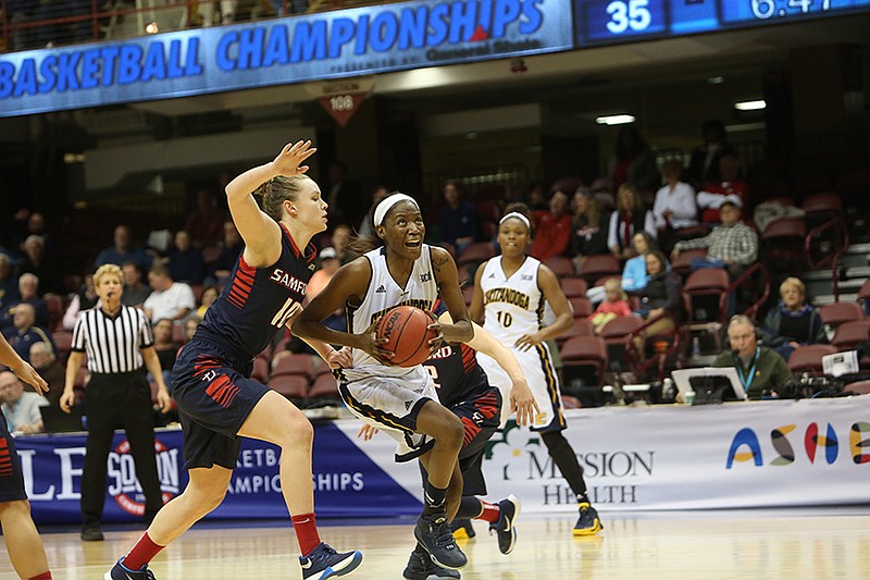 UTC's Jasmine Joyner drives past Samford's Taylor Reece for a basket during Friday afternoon's Southern Conference tournament semifinal game. Joyner had 17 points, 13 rebounds and eight blocked shots as the Mocs advanced to Sunday's championship game with a 49-41 win.