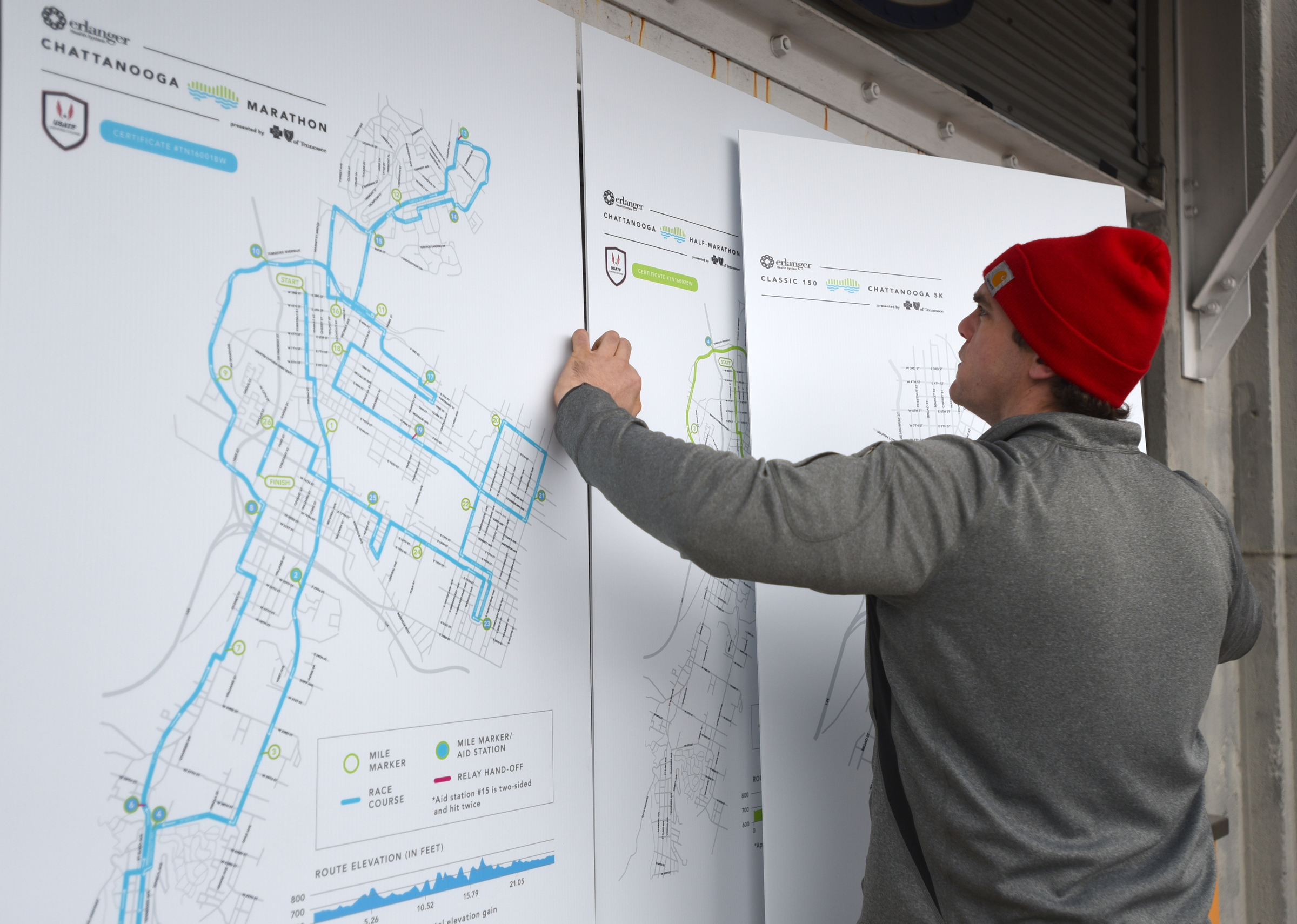 Sam Scaletta places route maps while setting up Friday, March 4, 2016 for Sunday's inaugural Erlanger Chattanooga Marathon at First Tennessee Pavilion.