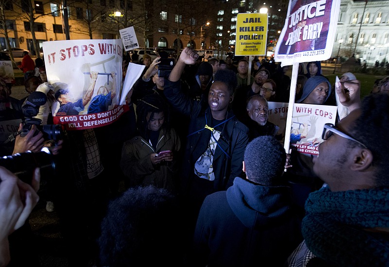 Demonstrators protest outside of the city hall in response to a hung jury and mistrial for Officer William Porter, one of six Baltimore city police officers charged in connection to the death of Freddie Gray, Wednesday, Dec. 16, 2015, in Baltimore Md. (AP Photo/Jose Luis Magana)