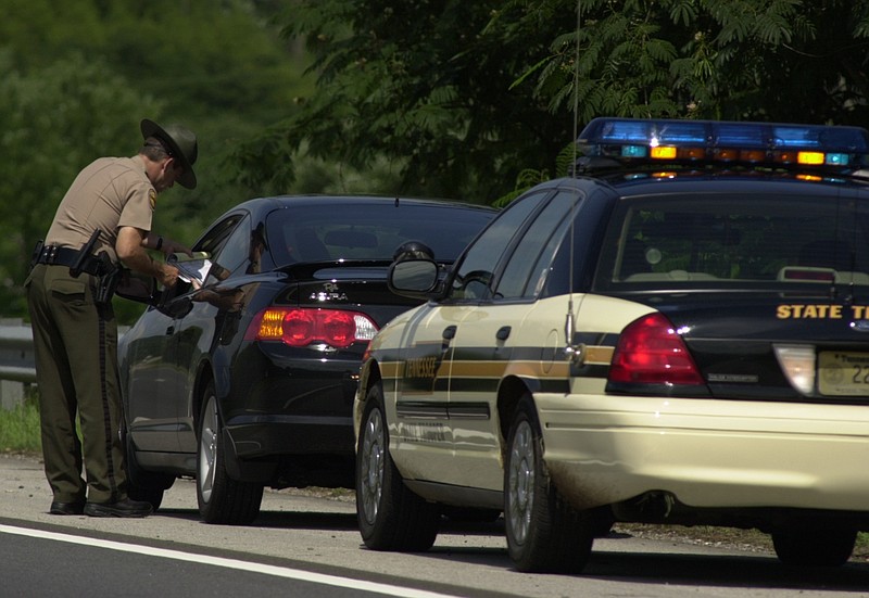 File photo - Trooper Hoyt James of the Tennessee Highway Patrol issues a speeding ticket to a motorist traveling 12 miles over the speed limit northbound on Highway 27 in 2016.  