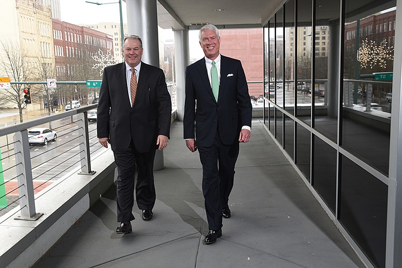 D. Michael Kramer, left, President and COO of Atlantic Capital in Chattanooga, and Douglas L. Williams, CEO of Atlantic Capital in Atlanta, walk on a second floor balcony above the 500 block of Broad Street and discuss the recent merger of FSG Bank and Atlantic Capital Bank.