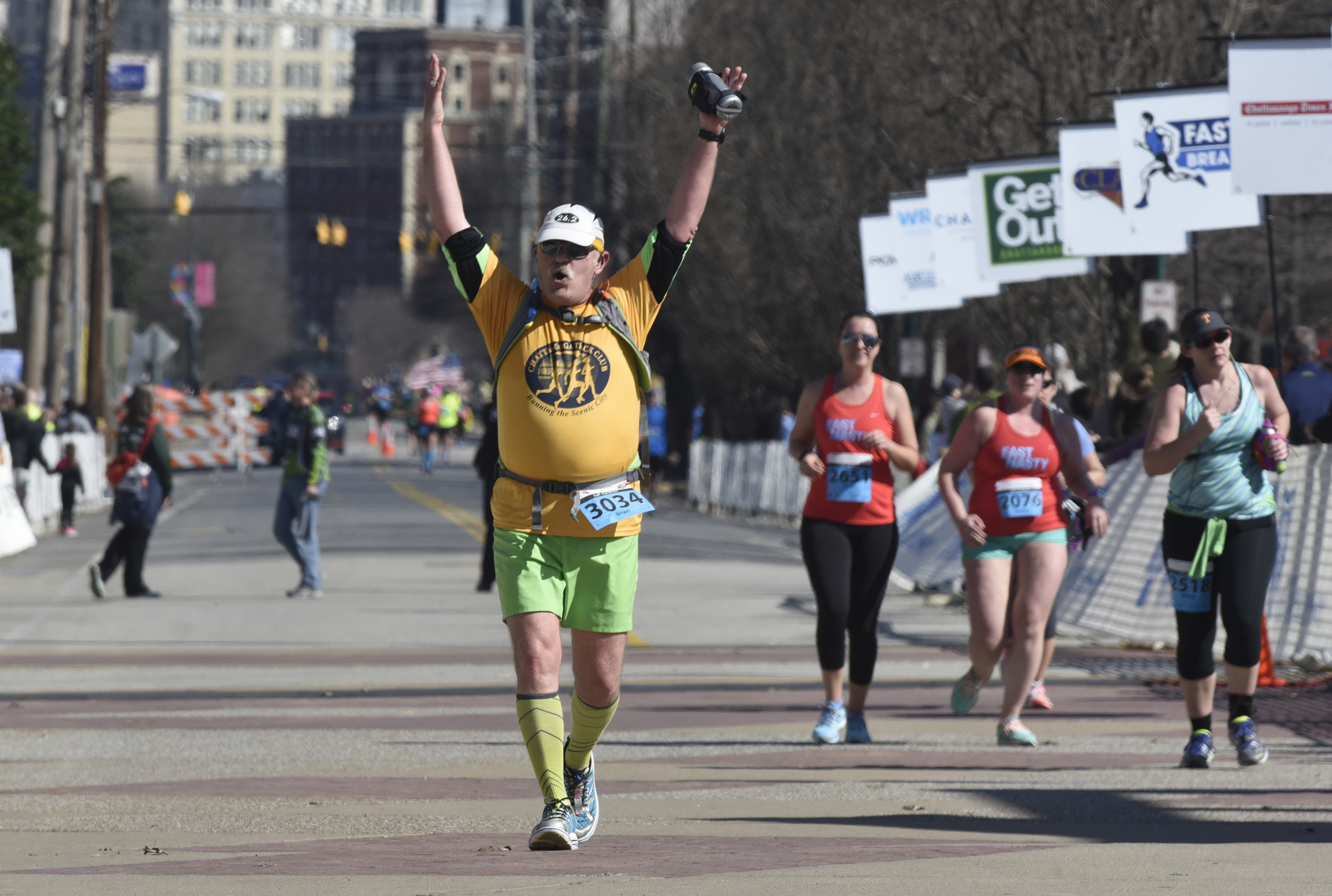Brian Tierney raises his arms as he approaches the finish line during the first running of the Chattanooga Marathon on Sunday, Mar. 6, 2016, in Chattanooga, Tenn.