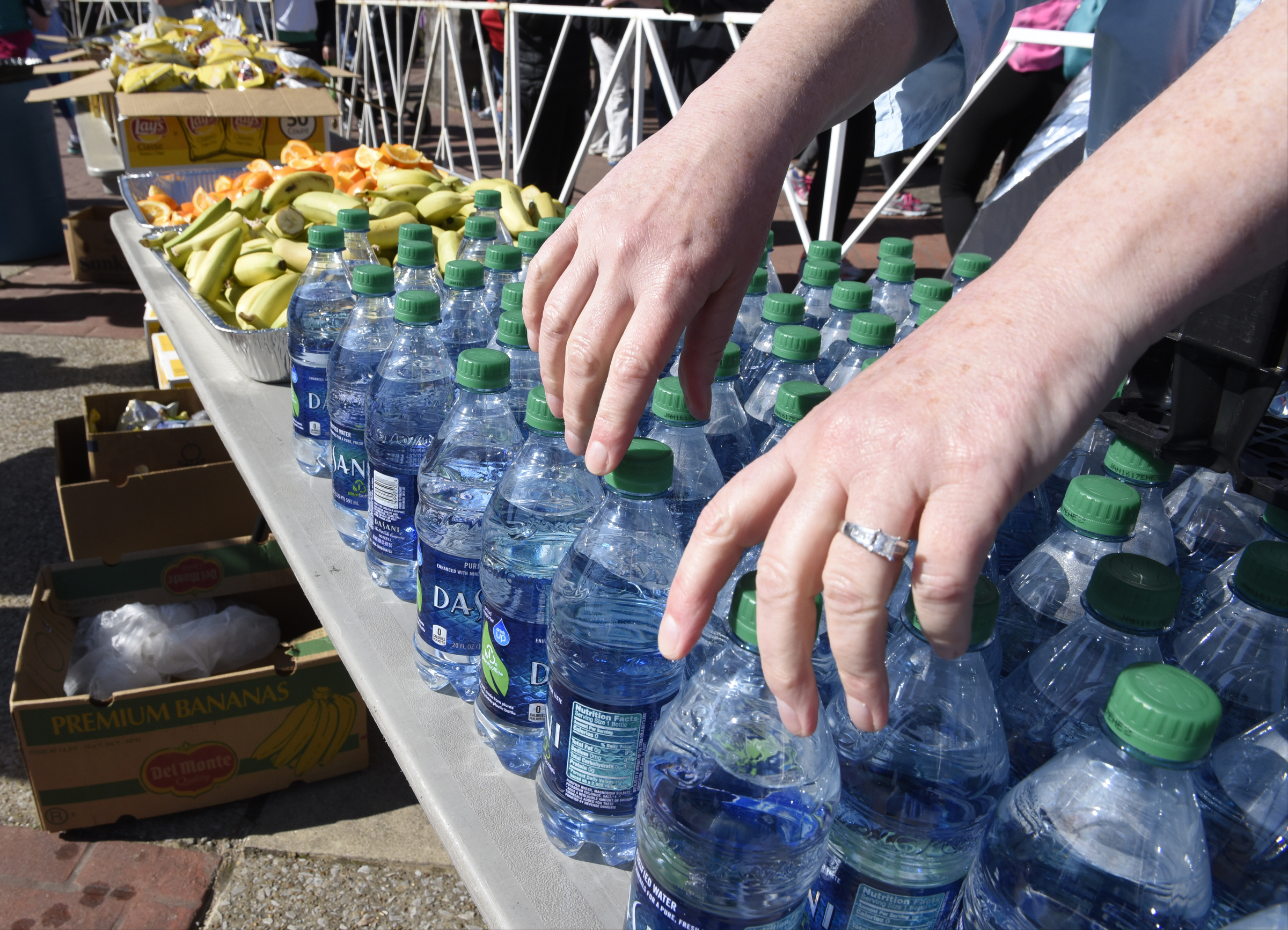 A volunteer arranges bottles of water for runners at the finish line at the Chattanooga Marathon on Sunday, Mar. 6, 2016, in Chattanooga, Tenn.
