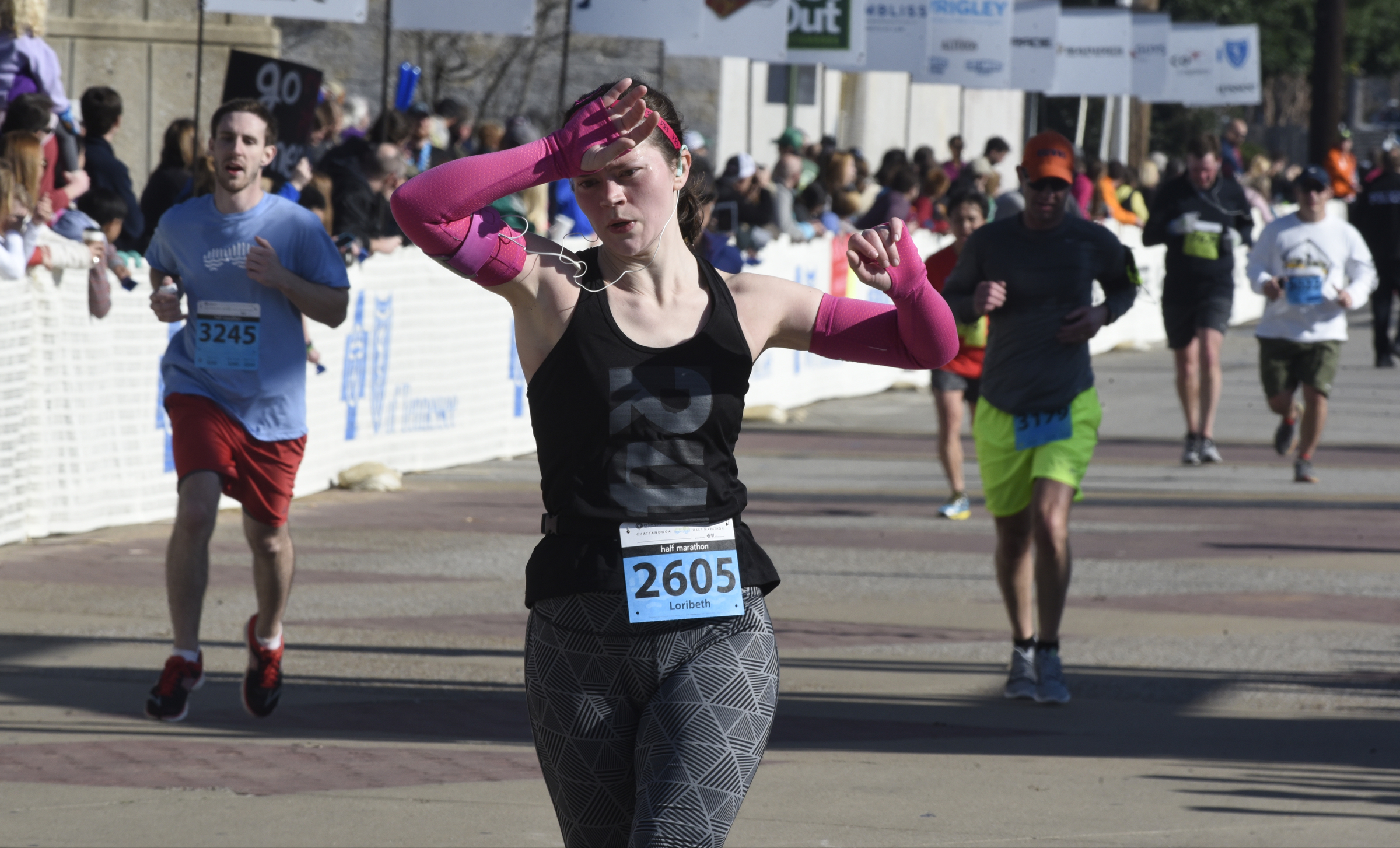 A woman wipes her brow as she crosses the finish line during the first running of the Chattanooga Marathon on Sunday, Mar. 6, 2016, in Chattanooga, Tenn.
