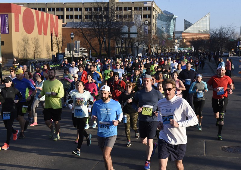 Runners cross Fourth Street during the first running of the Chattanooga Marathon on Sunday, Mar. 6, 2016, in Chattanooga, Tenn. 