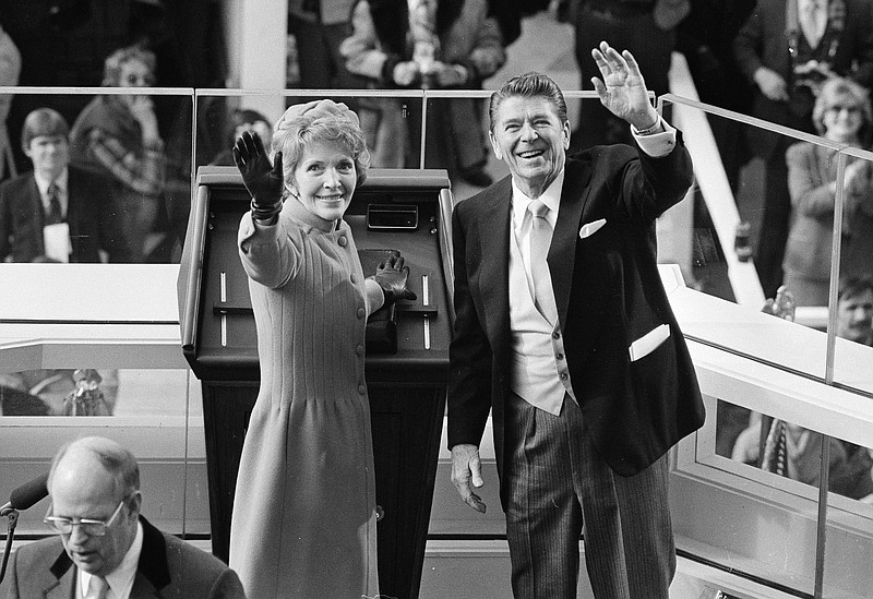 
              FILE - In this Jan. 20, 1981, file photo, President Ronald Reagan and first lady Nancy Reagan wave to onlookers at the Capitol building as they stand at the podium in Washington following the swearing in ceremony. The former first lady has died at 94, The Associated Press confirmed Sunday, March 6, 2016. (AP Photo/File)
            