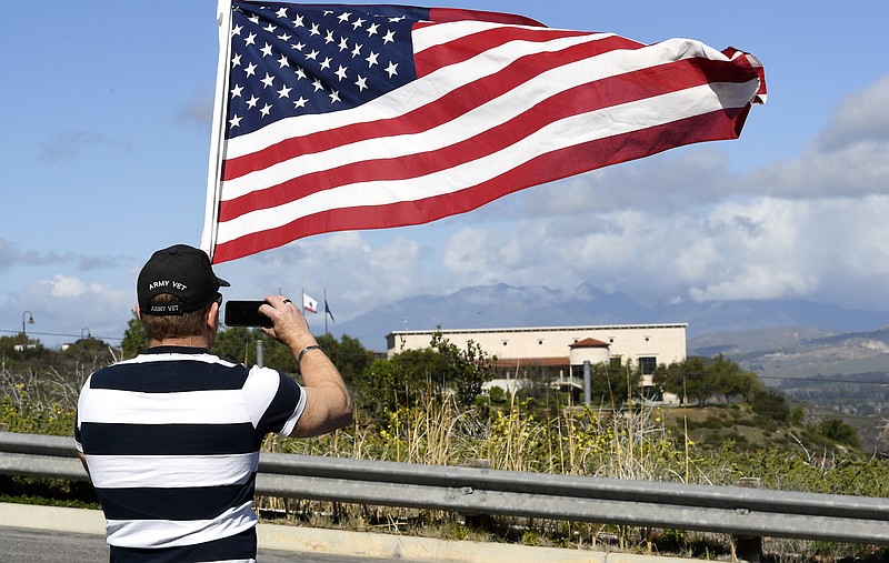 
              Andy Hall, of Simi Valley, Calif., takes a picture as he pays his respects at the Ronald Reagan Presidential Library, Sunday, March 6, 2016, in Simi Valley. Former first lady Nancy Reagan has died at 94. (AP Photo/Mark J. Terrill)
            