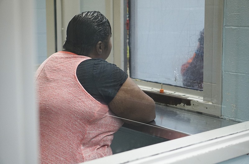 An inmate and his visitor talk during a scheduled visitation at the Hamilton County Jail.