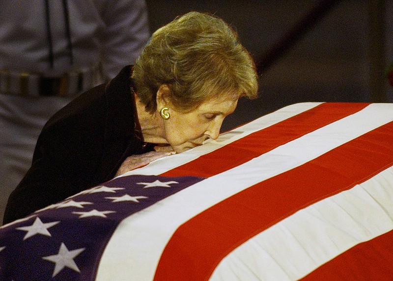 Former first lady Nancy Reagan kisses the casket of her husband, former President Ronald Reagan, prior to the removal of his remains from the Capitol Rotunda in 2004.