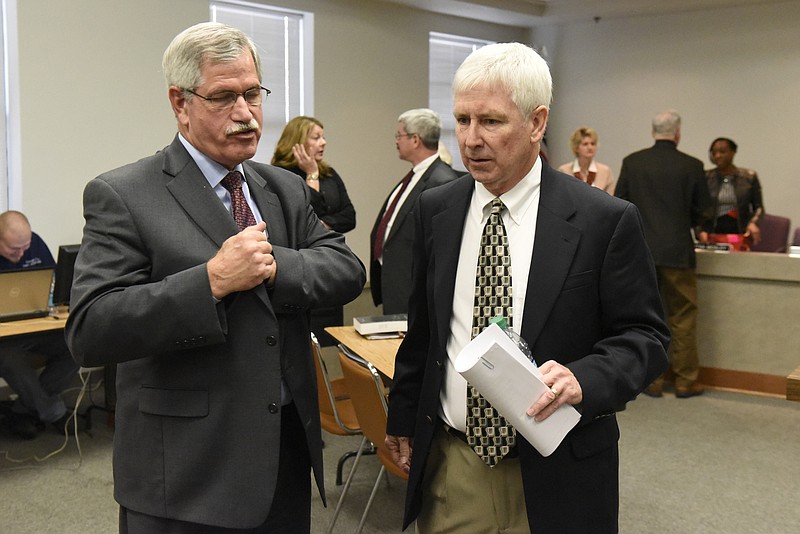 Rick Smith talks with board member Joe Galloway after the meeting of the Hamilton County School Board on Monday, Mar. 7, 2016, in Chattanooga, Tenn. The board declined to take action, leaving Rick Smith in place as superintendent. 