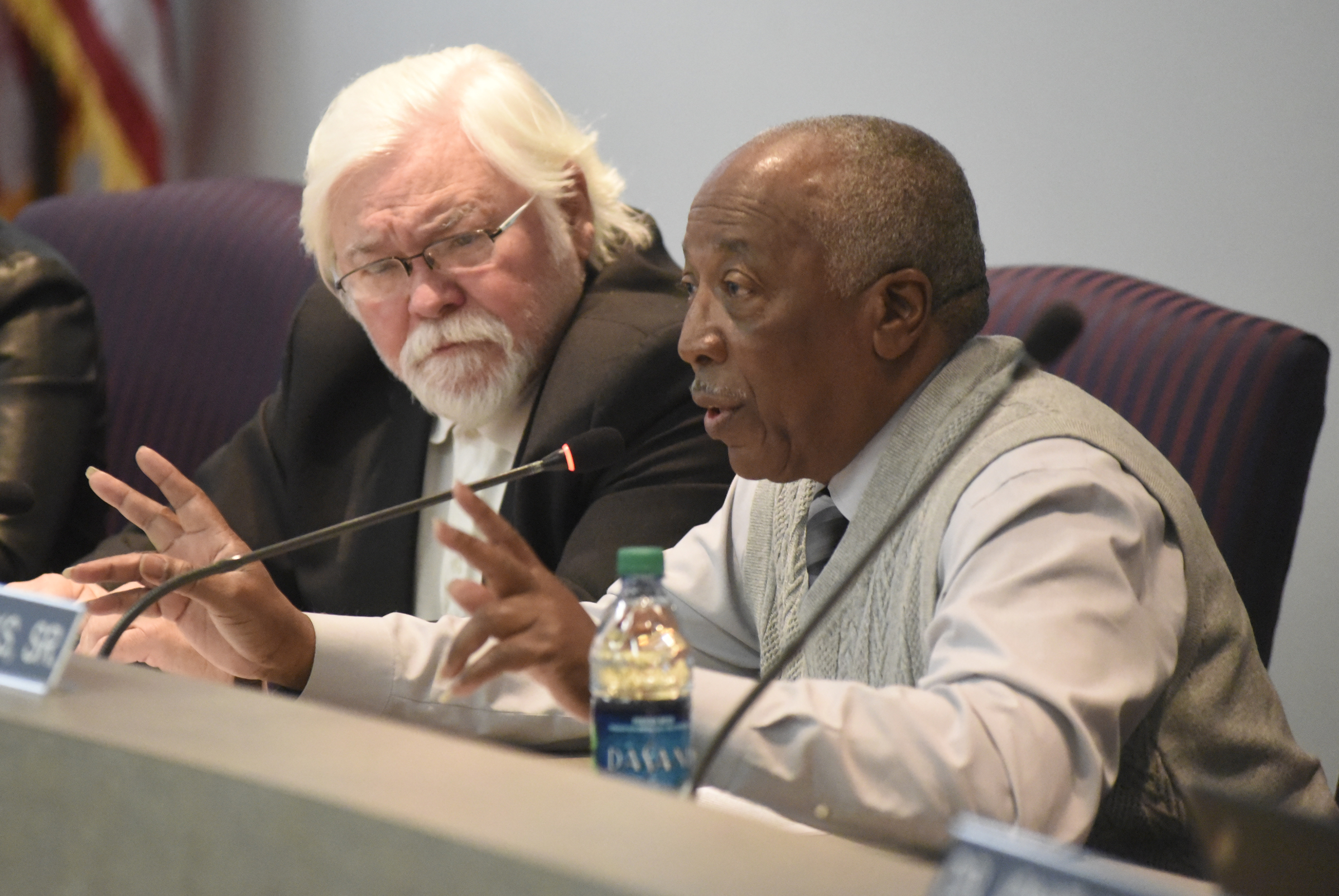 Board member George Ricks, Sr., speaks while Rick Testerman listens during the meeting of the Hamilton County School Board on Monday, Mar. 7, 2016, in Chattanooga, Tenn. The board declined to take action, leaving Rick Smith in place as superintendent.