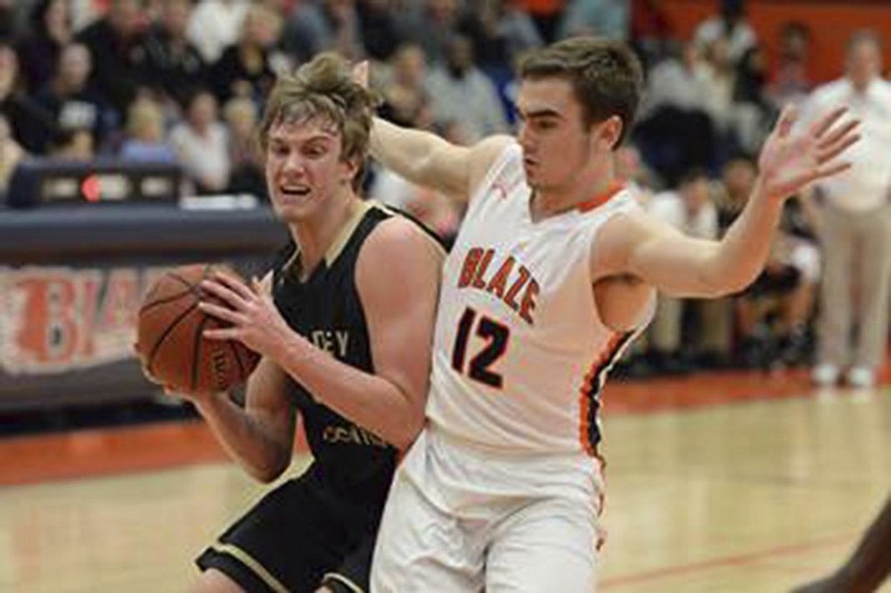 Bradley Central's Cole Copeland goes up for a shot as Blackman's Miller Armstrong (12) defends on the play.