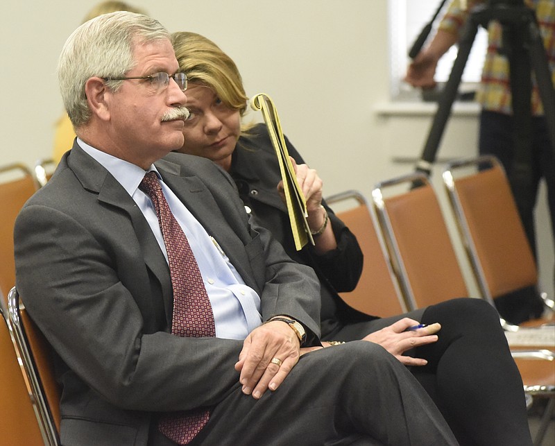 Attorney Leah Gerbitz, right, speaks to Rick Smith during the meeting of the Hamilton County School Board on Monday, Mar. 7, 2016, in Chattanooga, Tenn. The board declined to take action, leaving Rick Smith in place as superintendent. 