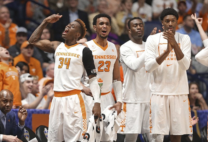 Tennessee's Devon Baulkman (34), Derek Reese (23), and others cheer during the first half of an NCAA college basketball game against Auburn in the Southeastern Conference tournament in Nashville, Tenn., Wednesday, March 9, 2016. (AP Photo/John Bazemore)