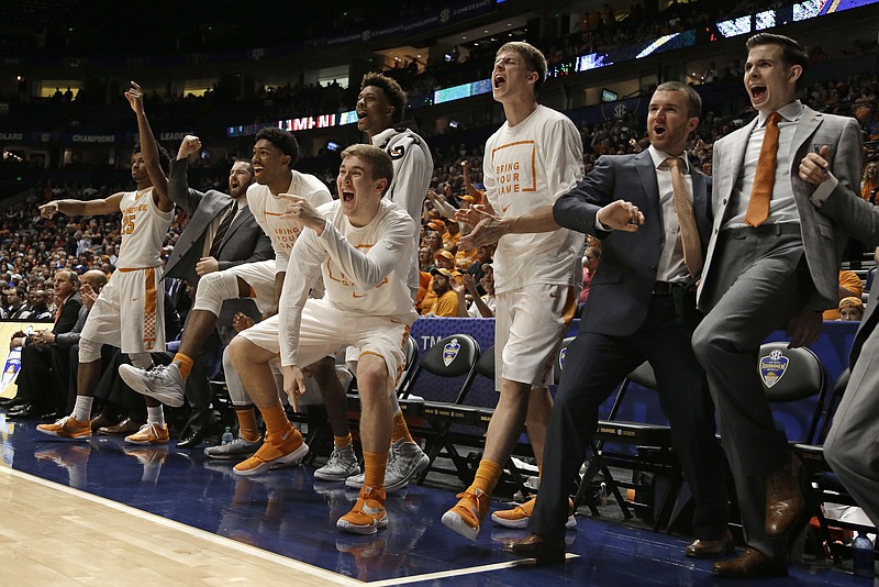 Tennessee players, coaches and staff cheer during the second half of an NCAA college basketball game against Auburn in the Southeastern Conference tournament in Nashville, Tenn., Wednesday, March 9, 2016. (AP Photo/Mark Humphrey)