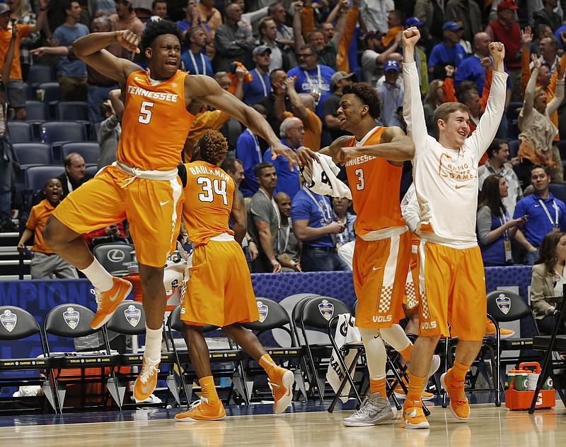 Tennessee players including Admiral Schofield (5) and Robert Hubbs III (3) celebrate after the Vols' 67-65 upset of Vanderbilt in the SEC tournament Thursday in Nashville. Vanderbilt's apparent tying basket at the end of the game was disallowed for being shot too late.