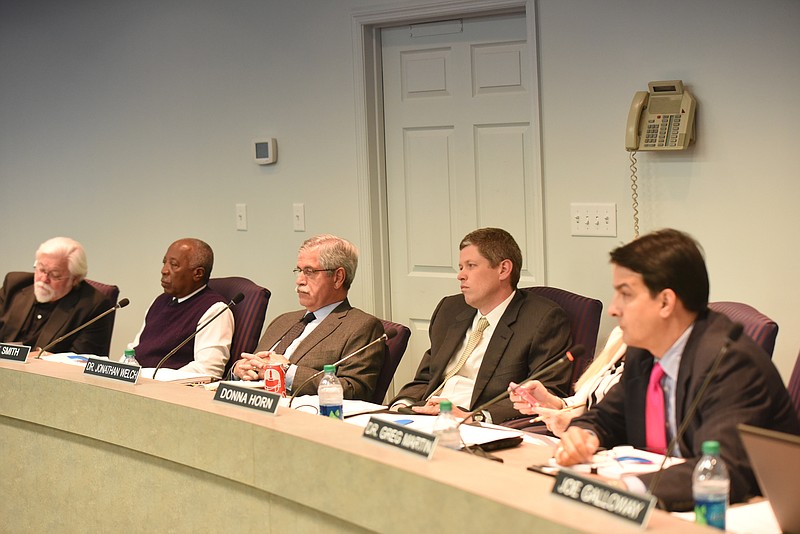 Former Superintendent of Schools Rick Smith, center, sits in his place during a Hamilton County School Board meeting.