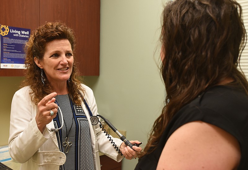 Physician's assistant Devony Webster talks with patient Amy Hill Tuesday, March 1, 2016 at UT Erlanger Primary Care on Lookout Mountain.