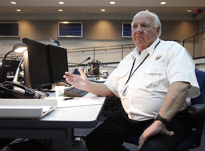 In this file photo the late Bill Tittle, Chief of Emergency Management in Hamilton County, sits at the Health Department's station during a disaster at the Hamilton County Emergency Operations Center inside the 9-1-1 Communications Center in Chattanooga on Monday.