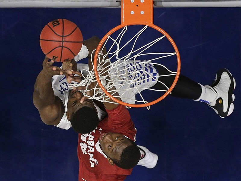 Kentucky's Alex Poythress, top, shoots as Alabama's Donta Hall, bottom, defends during the second half of an NCAA college basketball game in the Southeastern Conference tournament in Nashville, Tenn., Friday, March 11, 2016. Kentucky won 85-59. (AP Photo/Mark Humphrey)
