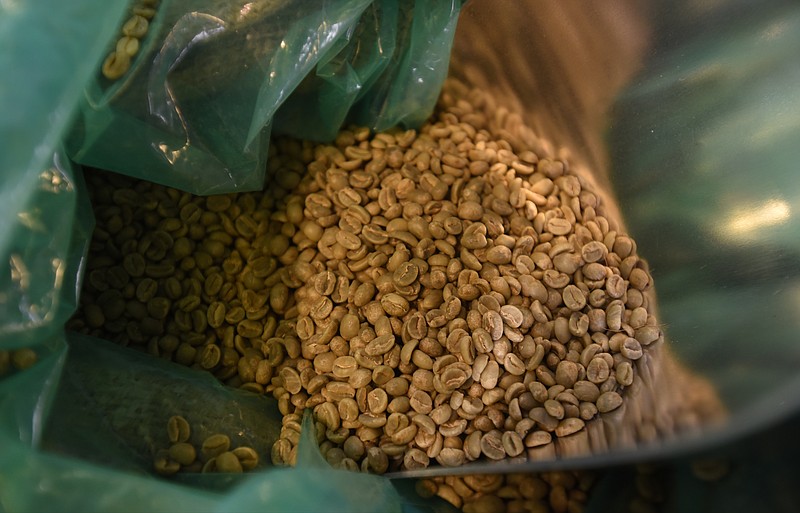 Unroasted coffee beans fill a bin Wednesday, February 24, 2016 in a St. Elmo shop.