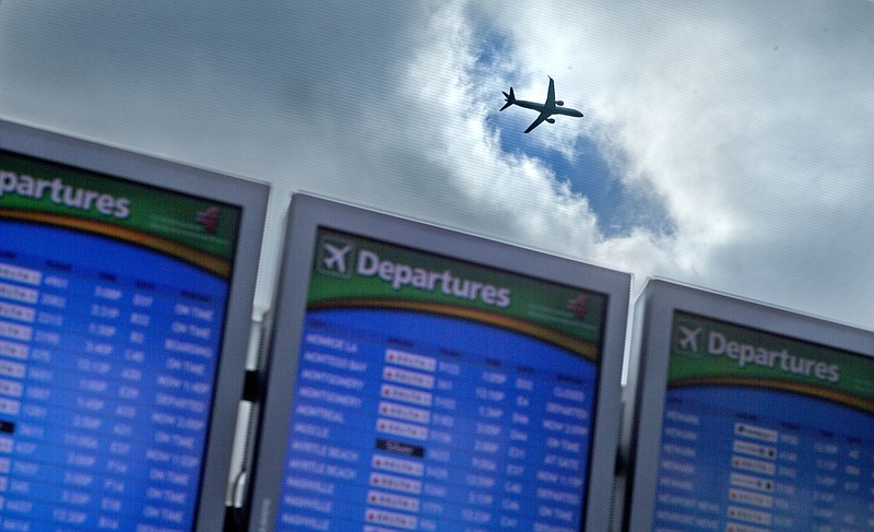 In this Wednesday, Nov. 27, 2013, file photo, a plane takes off over a departure board at Hartsfield-Jackson Airport, in Atlanta. Officials in Atlanta are laying the groundwork for an expansion of the world's busiest airport. According to a news release from the Metro Atlanta Chamber, work will begin soon on a $6 billion expansion and renovation project at the airport. (AP Photo/David Goldman, File)