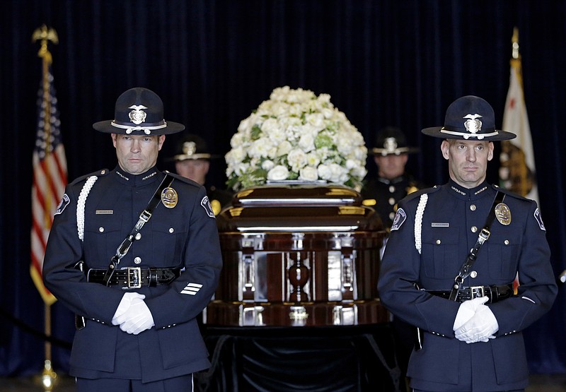 In this Thursday, March 10, 2016 file photo, four honor guards stand near the casket of Nancy Reagan at the Ronald Reagan Presidential Library, in Simi Valley, Calif. The former first lady will be buried beside her "Ronnie" Friday, March 11, 2016, at the library they loved, after being mourned and celebrated by family and hundreds of friends from Hollywood, Washington and beyond in a private service. Mrs. Reagan, who died Sunday at 94, planned the smallest details of her funeral.