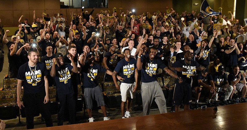 Members of the University of Tennessee at Chattanooga mens' basketball team and their fans erupt in cheers as they hear their selection during the NCAA tournament bracket broadcast shown in an auditorium at the UTC University Center Sunday, Mar. 13, 2016, in Chattanooga, Tenn. UTC will face Indiana in a first-round game on Thursday, Mar. 17, in Des Moines, Iowa.