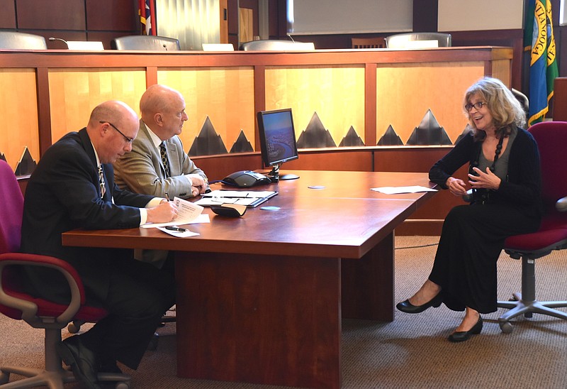 Olga de Klein, right, talks with John Clifton, left, and Tom Clark at an on-site re-accreditation  Monday, March 14, 2016 in the City Council chambers.