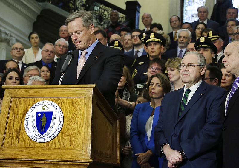 
              Massachusetts Gov. Charlie Baker becomes emotional as he speaks after signing sweeping legislation aimed at reversing a deadly opioid addiction crisis, during a signing ceremony at the Statehouse, Monday, March 14, 2016, in Boston. Listening at right are House Speaker Robert DeLeo, Senate President Stanley Rosenberg, and members of the legislature, law enforcement, health care providers, community leaders and individuals in recovery. (AP Photo/Elise Amendola)
            