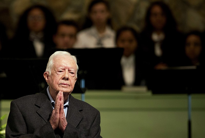 FILE - In a Sunday, Aug. 23, 2015 file photo, former President Jimmy Carter teaches Sunday School class at Maranatha Baptist Church in his hometown, in Plains, Ga. Carter's battle with cancer, which put a spotlight on his faith and led to an outpouring of support, is among the state's top stories of 2015. (AP Photo/David Goldman, File)