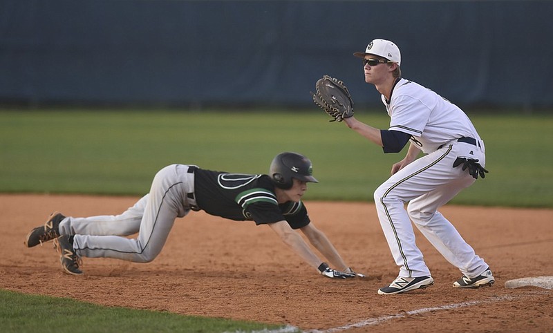 Soddy-Daisy's Luke Ellis makes the catch as East Hamilton's Lee Hester dives safely back to first Tuesday, March 15, 2016 at Soddy-Daisy High School.