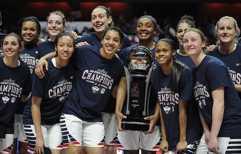 
              FILE- In this March 7, 2016, file photo, Connecticut players pose with the championship trophy at the end of a NCAA college basketball game in the American Athletic Conference tournament finals against South Florida at Mohegan Sun Arena in Uncasville, Conn. UConn was the top overall seed in the women's NCAA Tournament that was revealed Monday, March 14, 2016. (AP Photo/Jessica Hill, File)
            