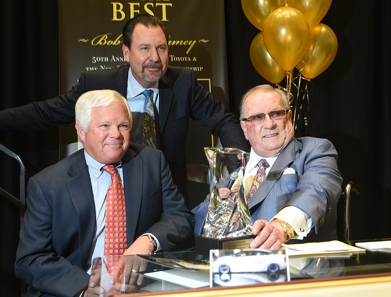 Celebrating 50 years of selling Toyota's from his Lee Highway dealership, Bob McKamey, right, is honored by Paul Holdridge, left, vice president of sales in the U.S., and Scott Wracher, general manager of the Toyota Regional District that includes Tennessee.