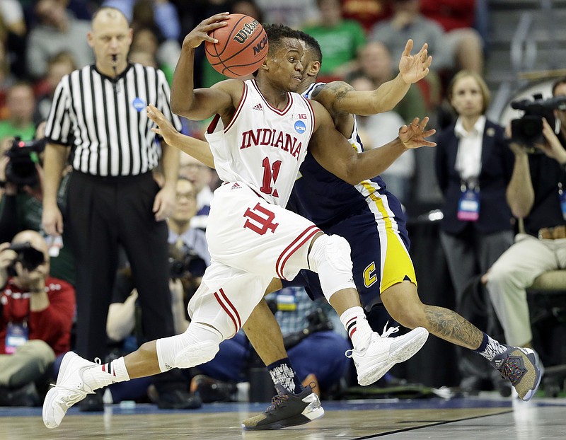 
              Indiana guard Yogi Ferrell drives past Chattanooga guard Johnathan Burroughs-Cook, right, during the first half of a first-round men's college basketball game in the NCAA Tournament, Thursday, March 17, 2016, in Des Moines, Iowa. (AP Photo/Charlie Neibergall)
            