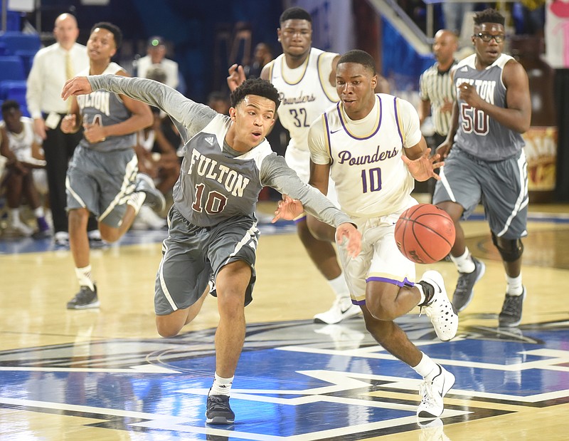 Knoxville Fulton's Donovan Filer knocks the ball away from Central's Dajon Baxter Thursday, March 17, 2016 at Murphy Center at Middle Tennessee State University.