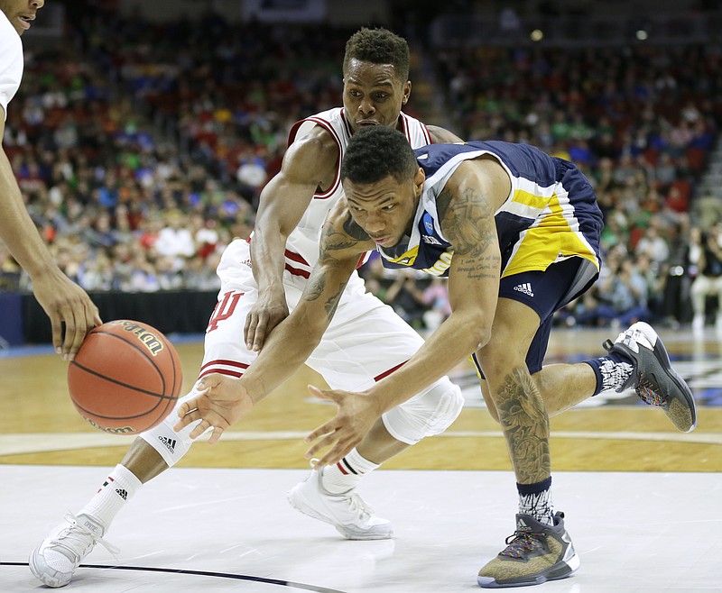 Chattanooga guard Johnathan Burroughs-Cook loses the ball in front of Indiana guard Yogi Ferrell, left, while driving to the basket during the first half of a first-round men's college basketball game in the NCAA Tournament, Thursday, March 17, 2016, in Des Moines, Iowa. (AP Photo/Charlie Neibergall)