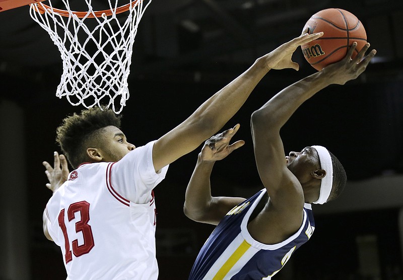 Indiana forward Juwan Morgan blocks a shot by Chattanooga guard Dee Oldham, right, during the first half of a first-round men's college basketball game in the NCAA Tournament, Thursday, March 17, 2016, in Des Moines, Iowa. (AP Photo/Charlie Neibergall)