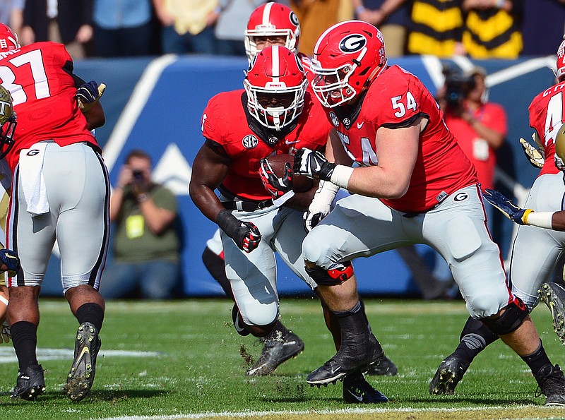 Georgia offensive lineman Brandon Kublanow, shown here blocking for tailback Sony Michel in the November win at Georgia Tech, ended last season as the right guard but began spring practice this week back at center.