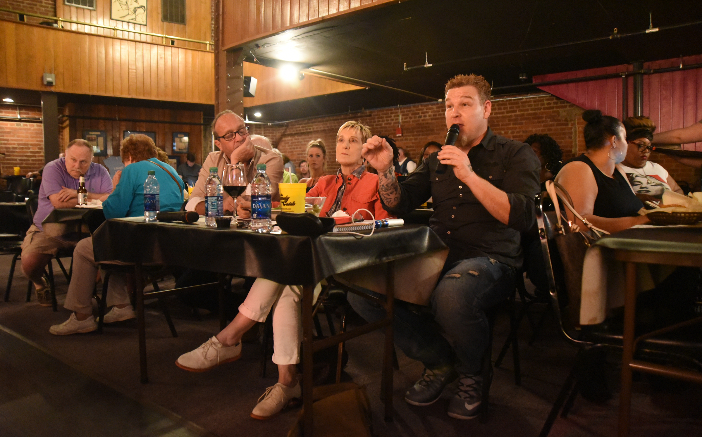 Judges Jerry Harvey, Karen Mills and Michael Alfano, from right, critique a performance during a competition for local comics on Wednesday, March 16, 2016 at Chattanooga's Comedy Catch.