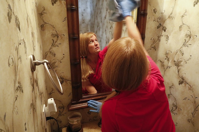 Staff Photo by Dan Henry / The Chattanooga Times Free Press- 3/15/16. Jessica Kittle, 31, with Two Maids and a Mop cleaning service, performs a deep clean on Jacob McDonald's residence on Tuesday, March 15, 2016. 