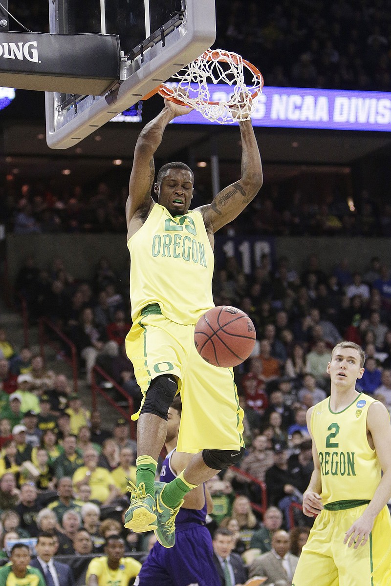 
              Oregon forward Elgin Cook (23) dunks during the second half of a first-round men's college basketball game in the NCAA Tournament against Holy Cross in Spokane, Wash., Friday, March 18, 2016. (AP Photo/Young Kwak)
            