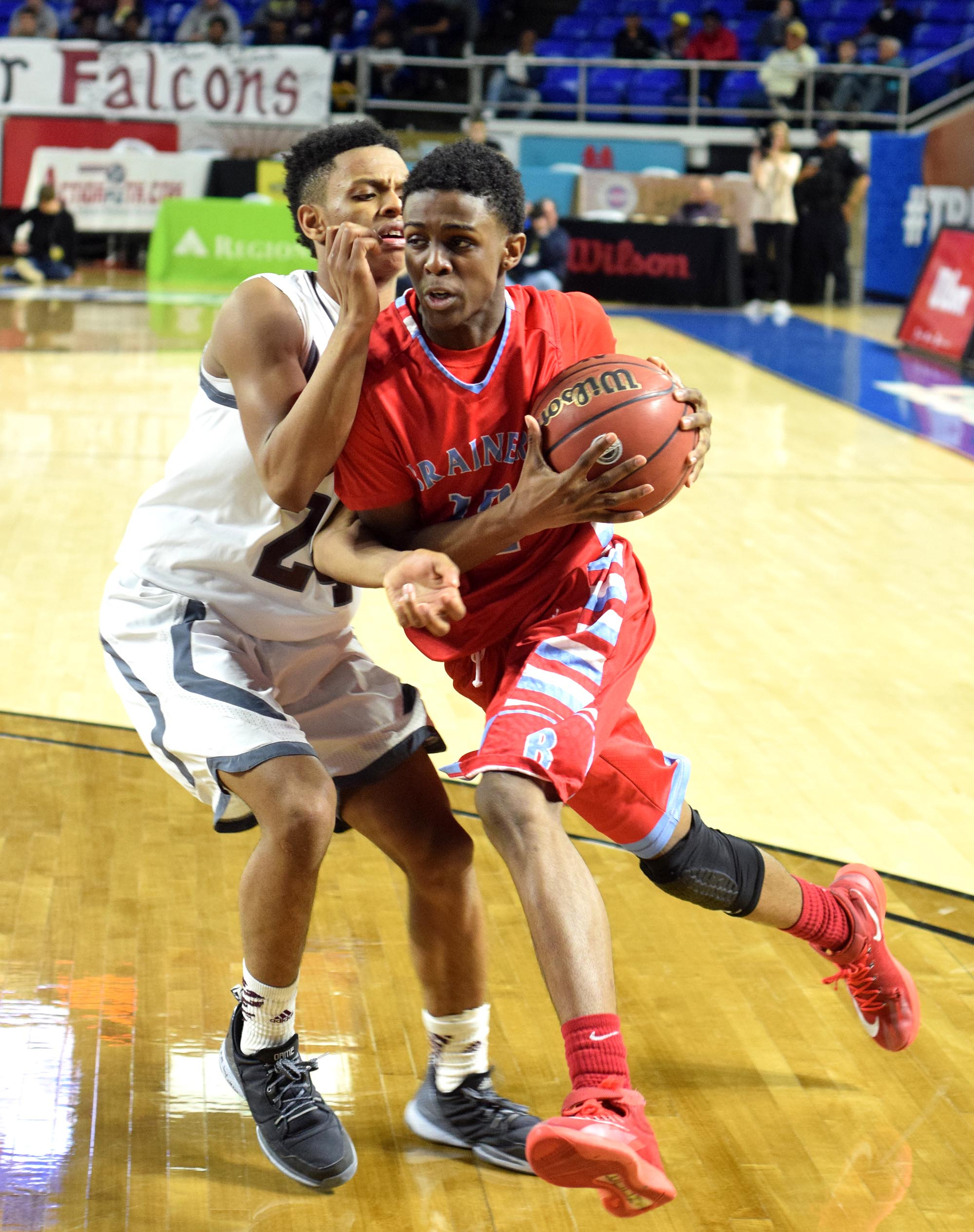 Brainerd's Vesta Melvin (12) drives past Fulton's Ron Davis III (24). The Brainerd High Panthers faced the Fulton High Falcons in the TSSAA State Division I Class AA Championship at the Murphy Center on the campus of Middle Tennessee State University in Murfreesboro March 19, 2016.