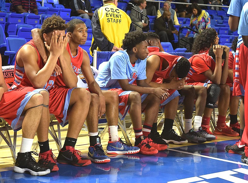 The Brainerd Panthers react to their championship loss Saturday night against Fulton's Falcons in the Murphy Center at Middle Tennessee State University.