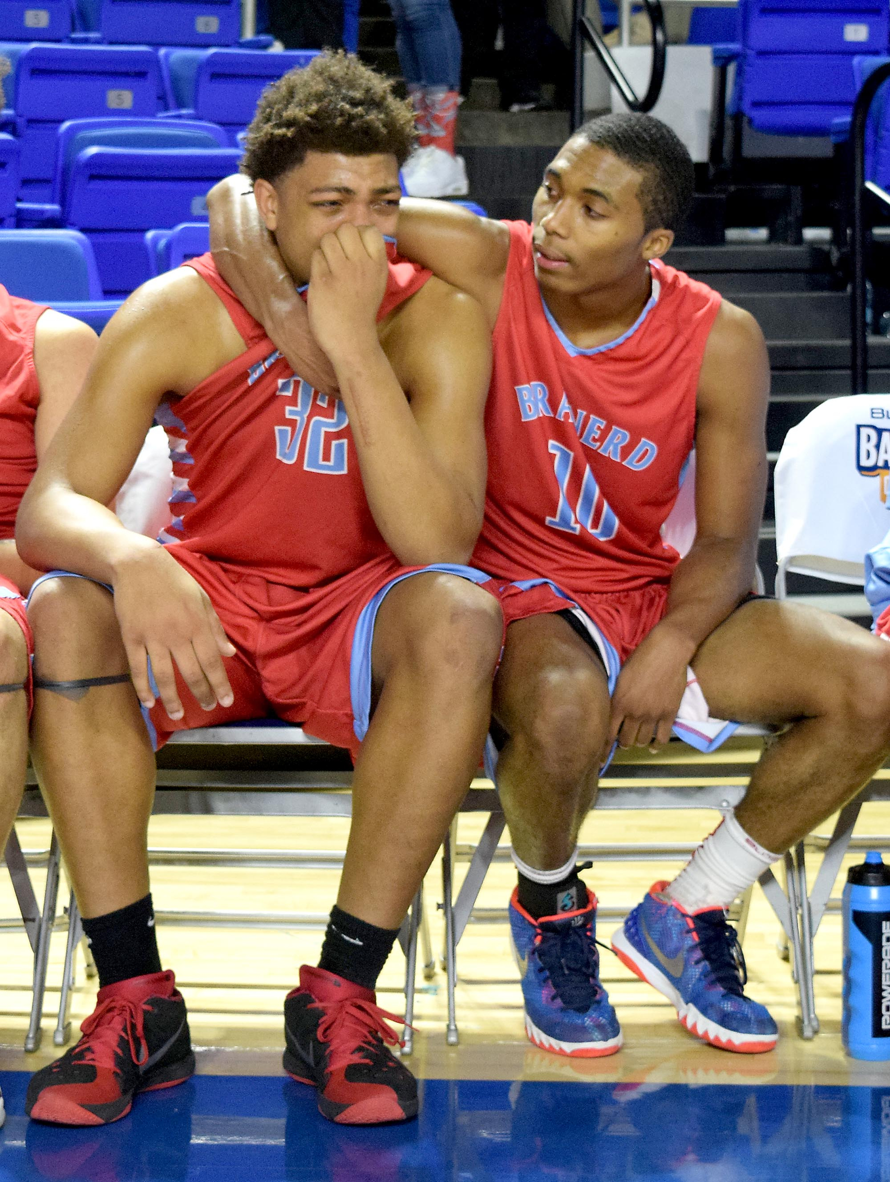 Kentrell Davis (10) consoles Jesse Walker after Brainerd's 59-50 loss to Fulton. The Brainerd High Panthers faced the Fulton High Falcons in the TSSAA State Division I Class AA Championship at the Murphy Center on the campus of Middle Tennessee State University in Murfreesboro March 19, 2016.