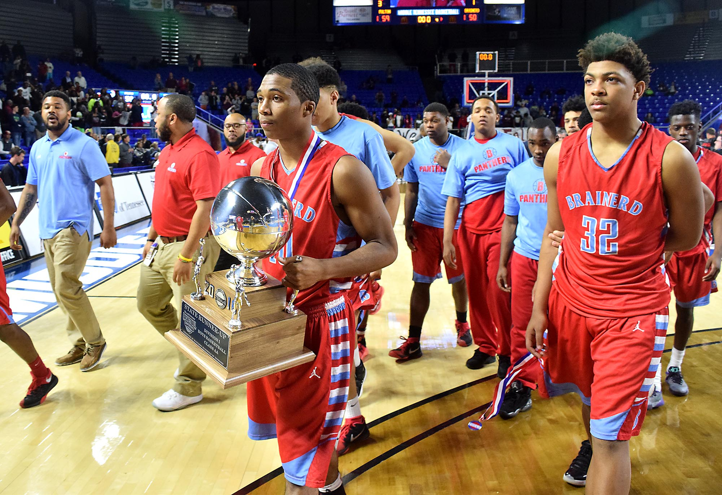 Brainerd's Kentrell Evans (10) carries the runner-up trophy off the court. The Brainerd High Panthers faced the Fulton High Falcons in the TSSAA State Division I Class AA Championship at the Murphy Center on the campus of Middle Tennessee State University in Murfreesboro March 19, 2016.